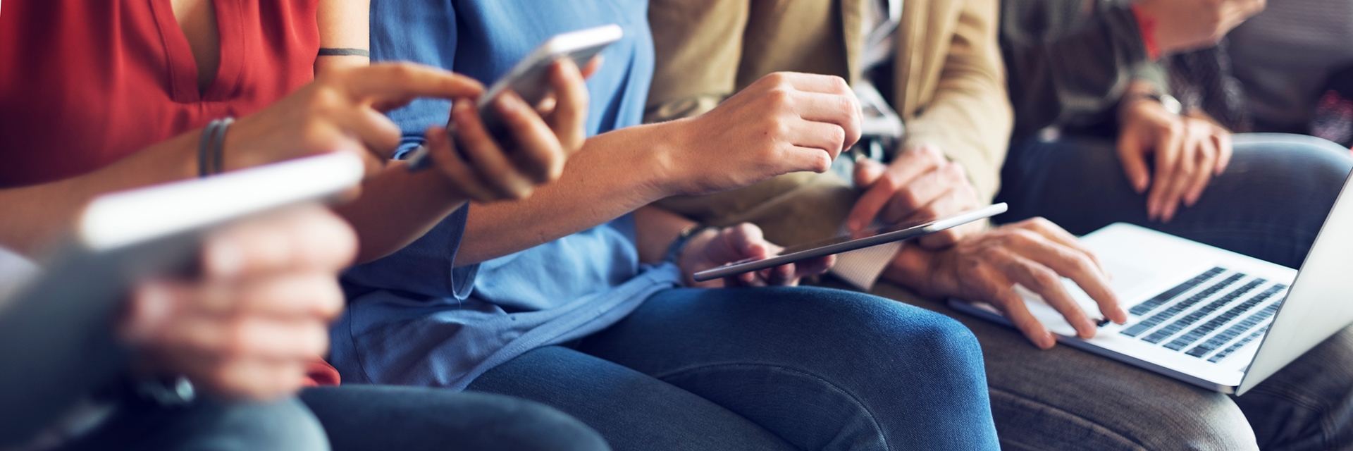 group of people working on cellphones or laptop